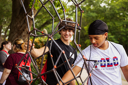 The metal sculpture substituting as the new gum tree while student place gum on it.