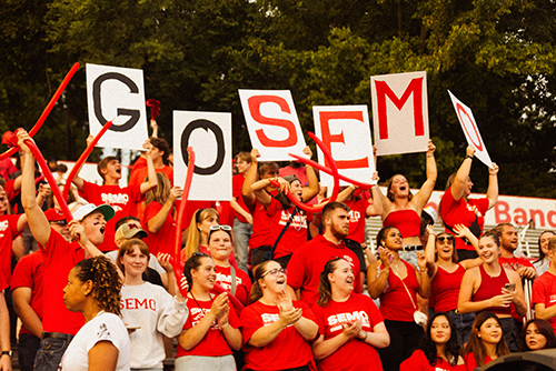 Students hold "GO SEMO" signs.