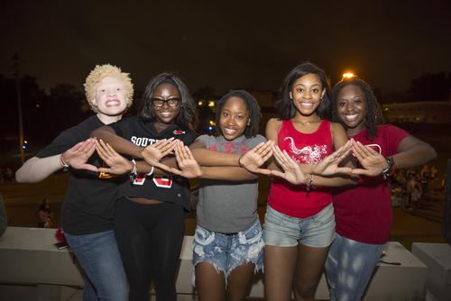 Students pose for a photo at Greek meetup.