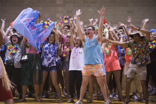 Students cheer and raise their arms during the Greek Games.